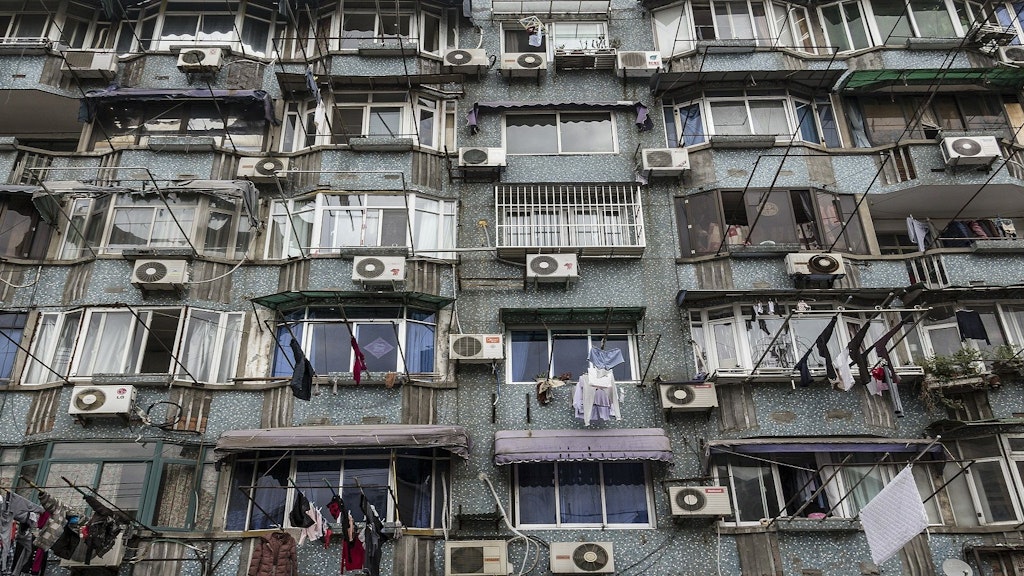 Façade d’un immeuble sur laquelle sont installés une multitude de vieux appareils de climatisation.