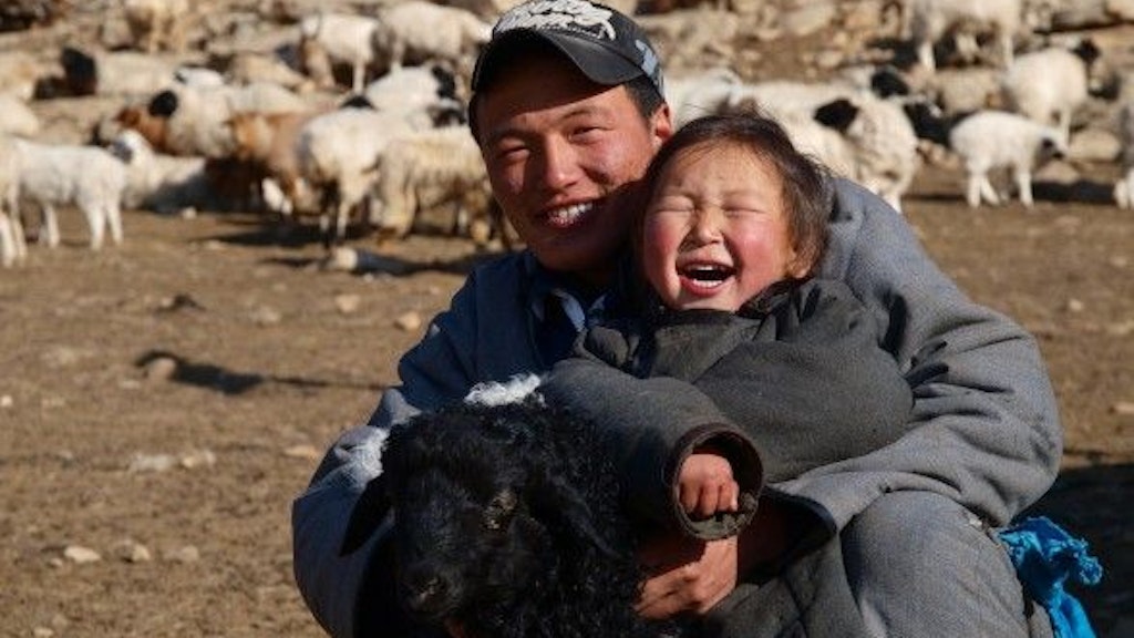 Mongolian shepherd with his son.