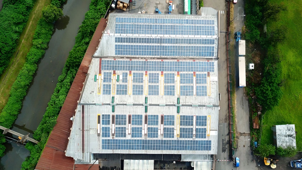 Photograph showing solar panels installed on the roof of a company in South Africa. 