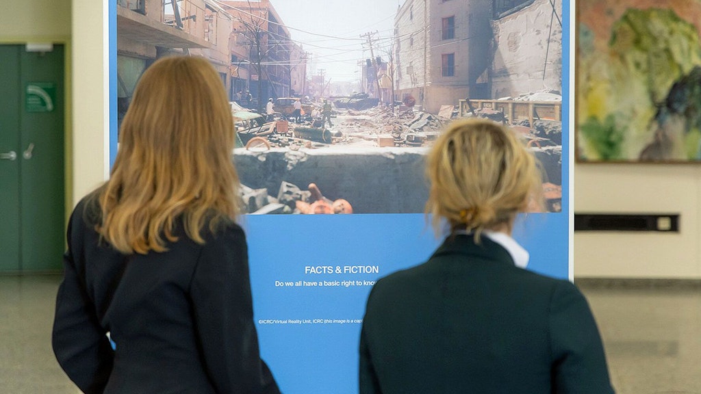 Two women at the Vienna exhibition viewing the virtual artwork 'ICRC / Virtual Reality Unit, ICRC'.