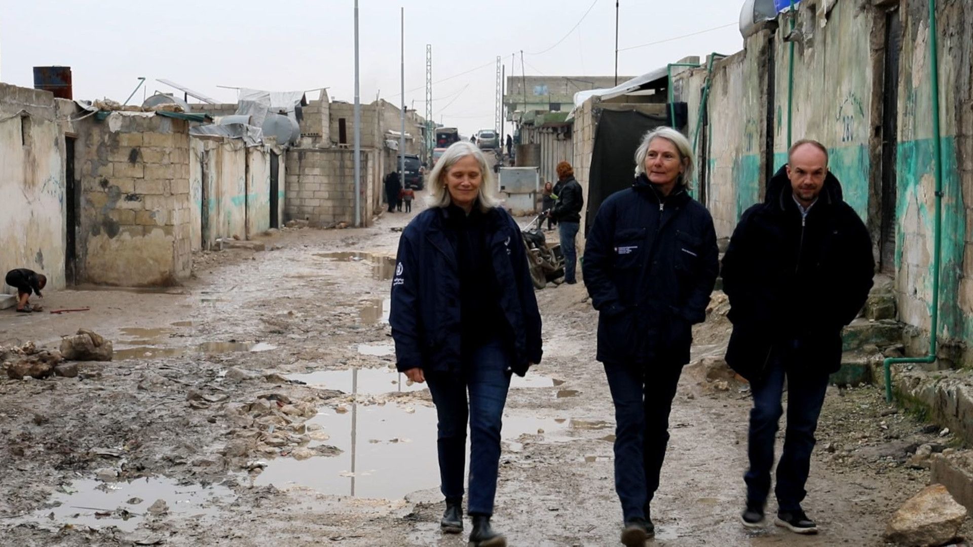 Caroline Tissot spaziert mit zwei anderen Personen durch die Strassen von Idlib.