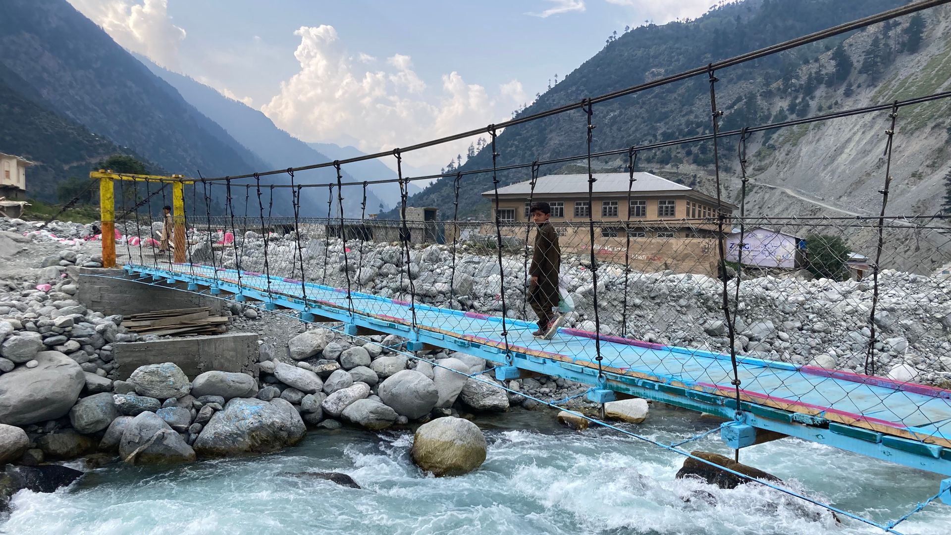 A child crosses a bridge restored by the SDC.