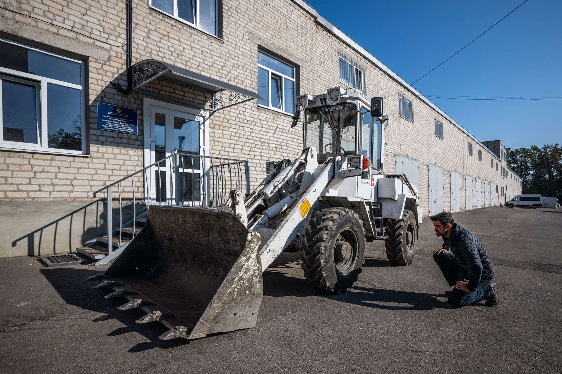 Urs Bächtold checks the condition of a handling machine donated by Switzerland.
