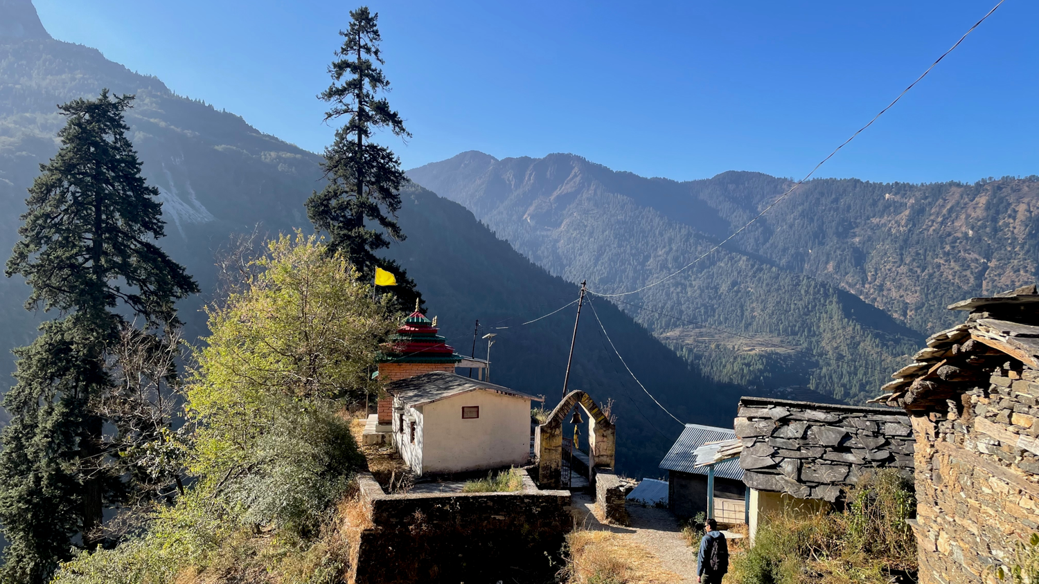 Small mountain village on a hill. In the background, you can see more mountain ranges.