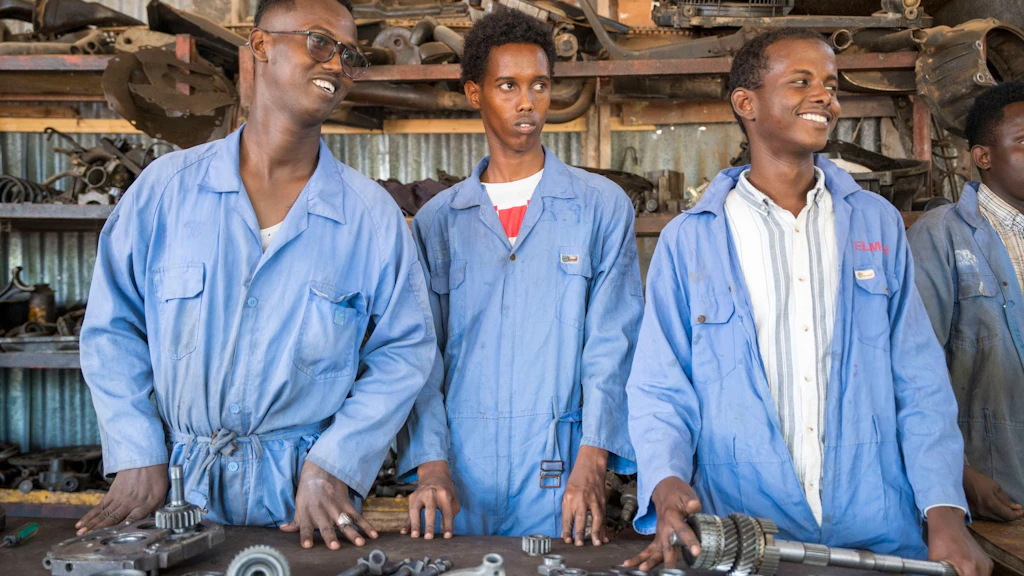 Young men in a mechanical workshop during vocational training.