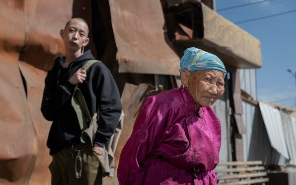 A young artist with his mother in traditional dress.