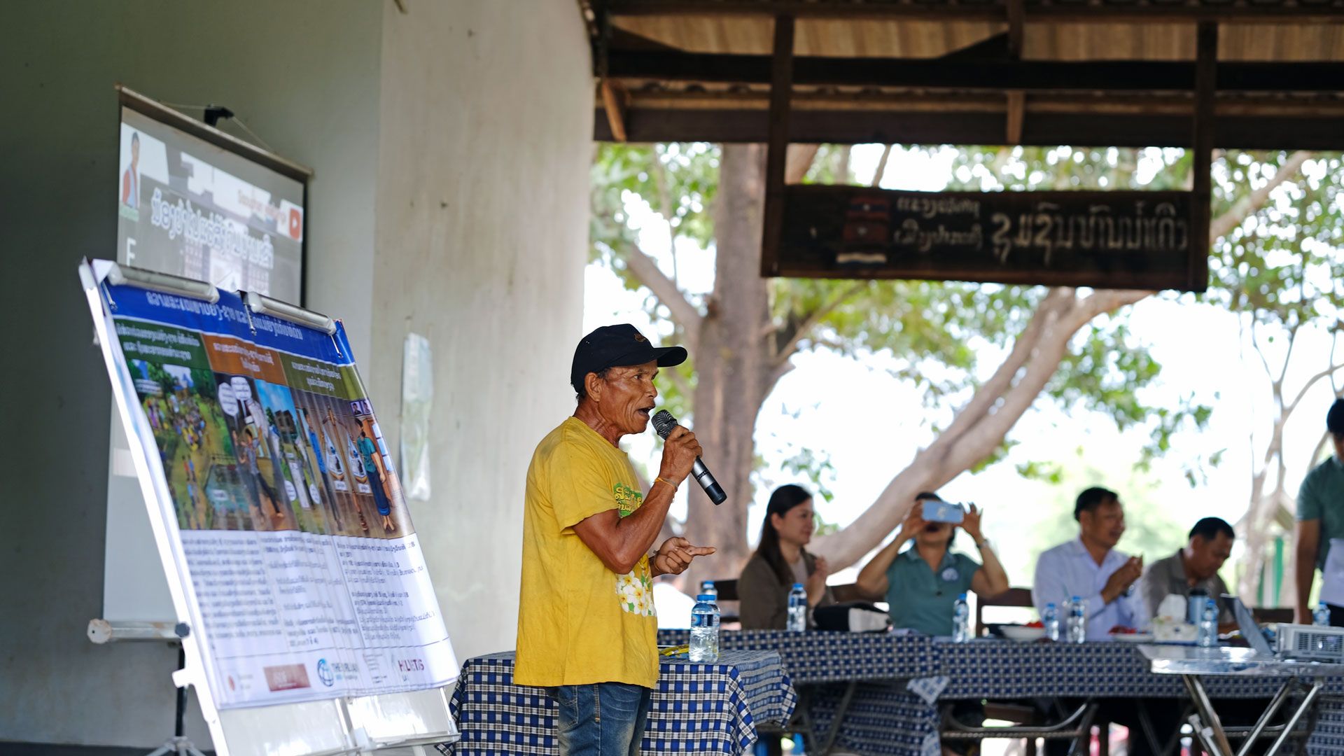 A villager speaks up at a land rights session.