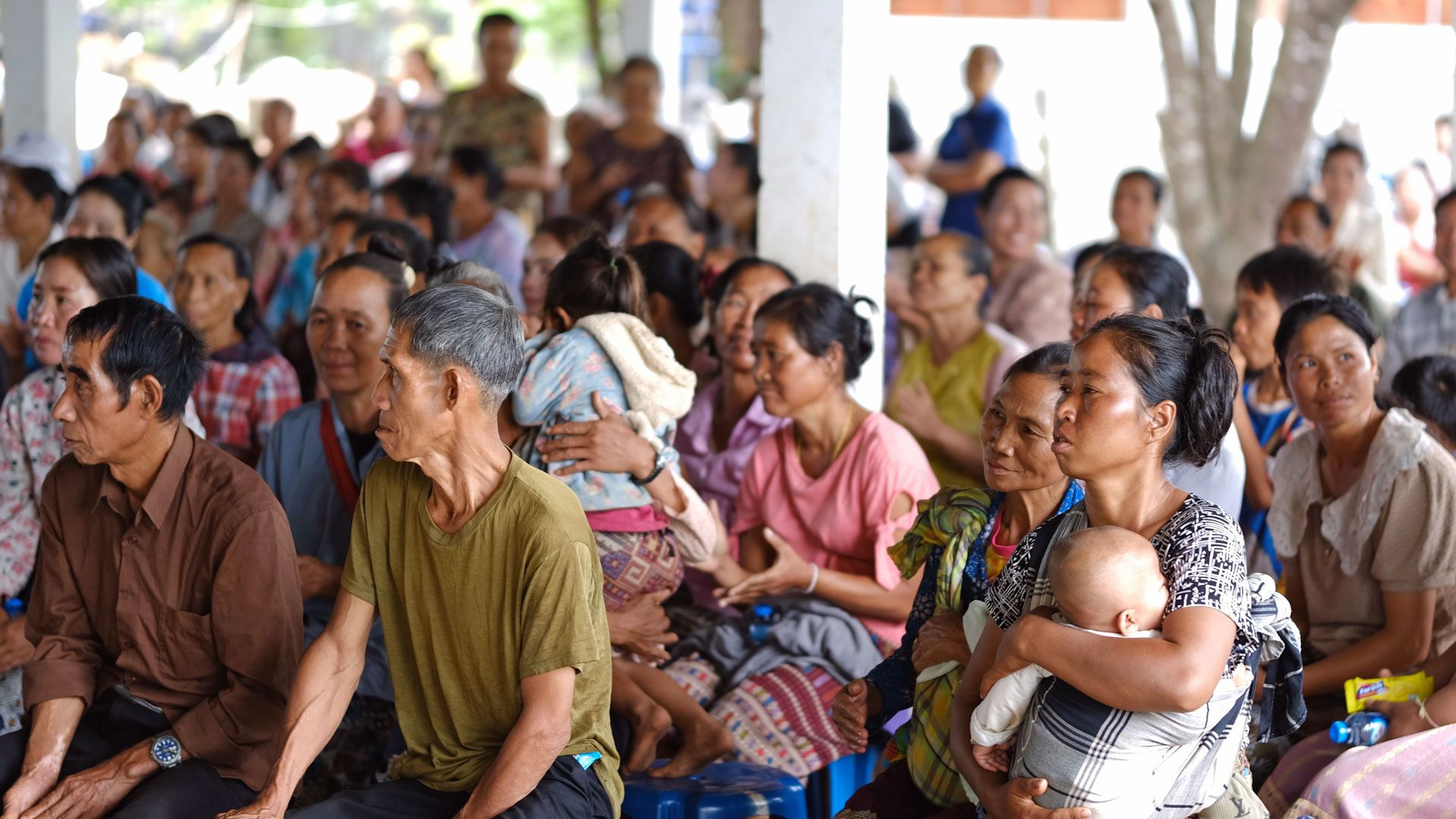 Villagers of all ages fill the hall.
