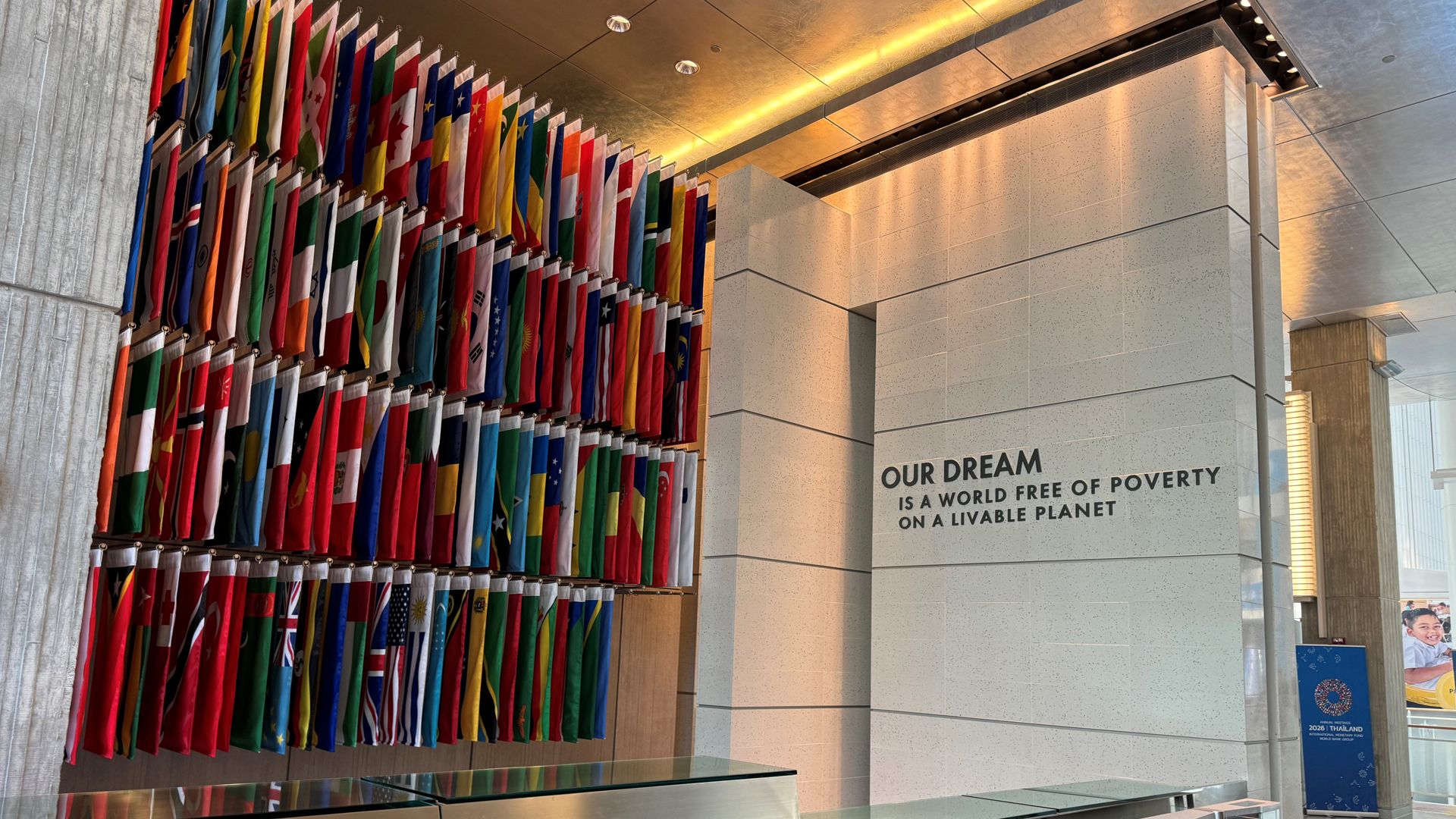 A sign on a wall in a building proclaims: "A world free of poverty on a livable planet."