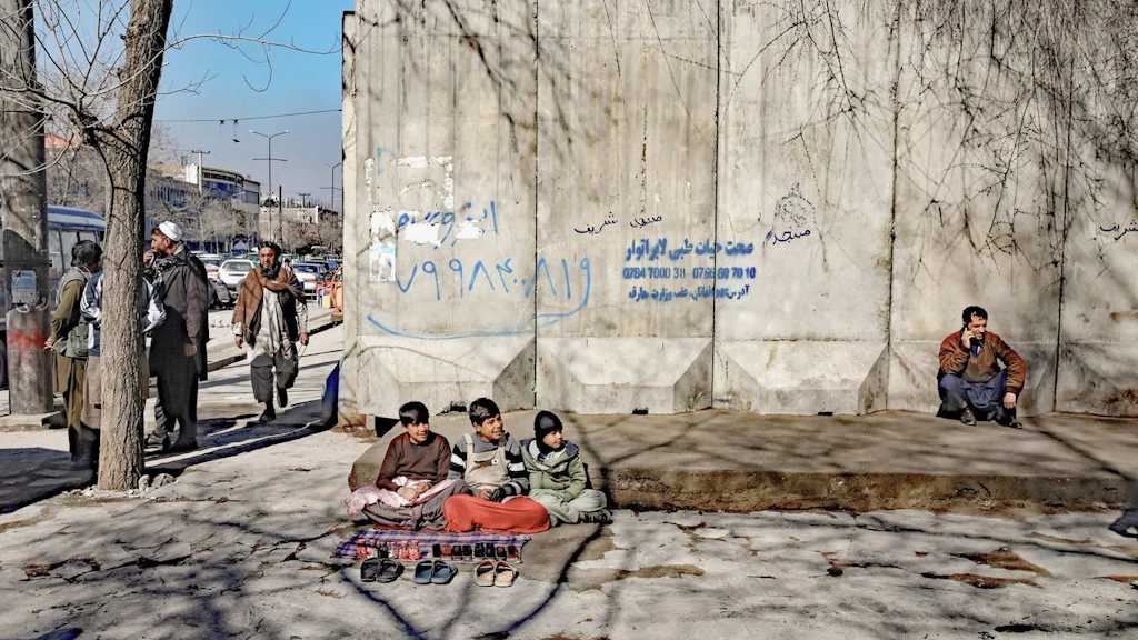 Children begging and selling shoes in Afghanistan's capital Kabul. 84% of 258 million children and adolescents worldwide who are out of school live in protracted crisis settings.