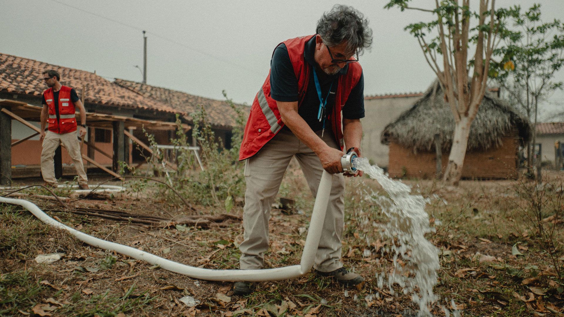 Un expert tient un tuyau d’un réservoir avec de l’eau qui coule.