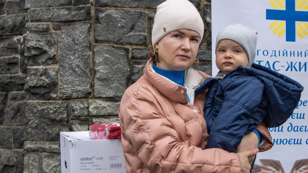 Une mère avec son enfant dans les bras.